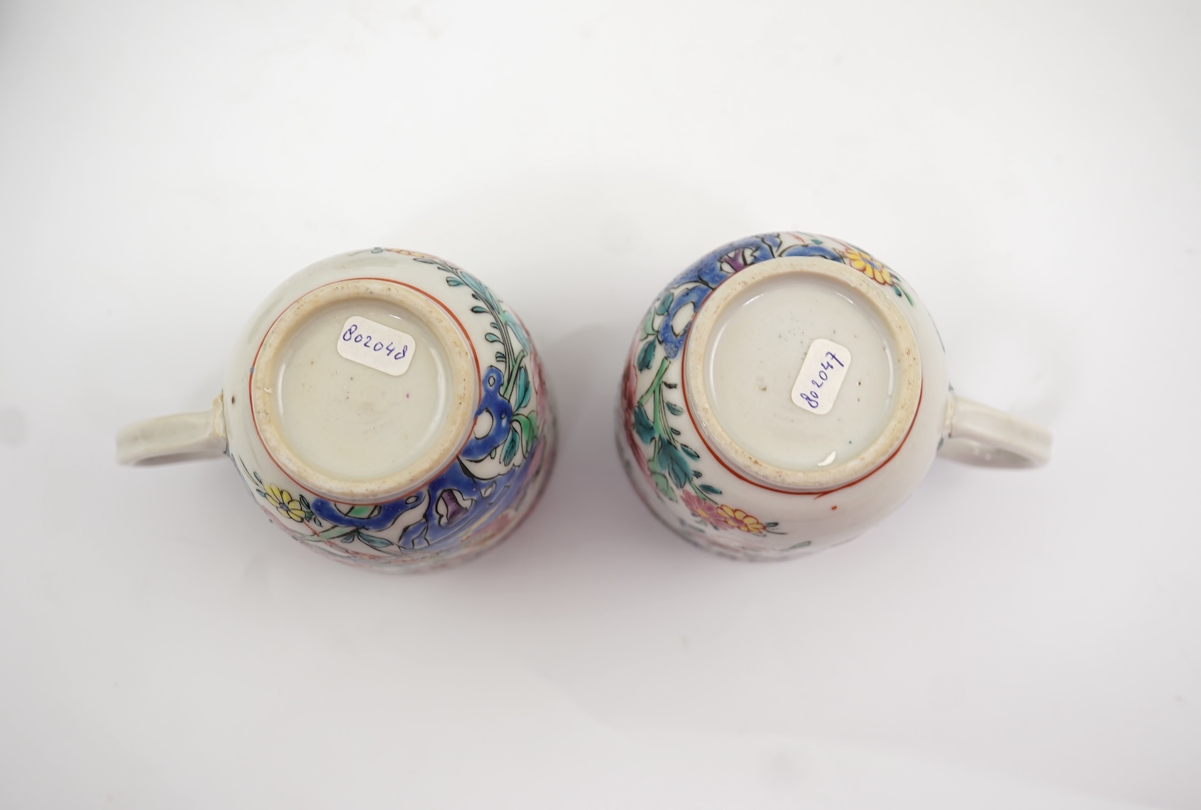 A near pair of Chinese famille rose ‘double pheasant’ coffee cups, early Qianlong period